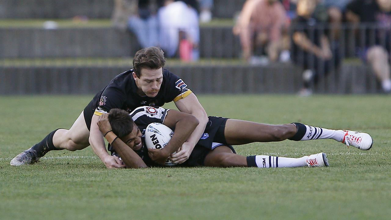 Redfern's TJ Speedy is tackled. Picture: John Appleyard