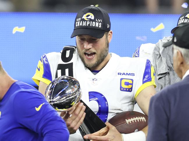 INGLEWOOD, CALIFORNIA - FEBRUARY 13: Matthew Stafford #9 of the Los Angeles Rams reacts as he holds the Vince Lombardi Trophy after the win against the Cincinnati Bengals following the NFL Super Bowl 56 football game at SoFi Stadium on February 13, 2022 in Inglewood, California. The Rams won 23-20. (Photo by Michael Owens/Getty Images)