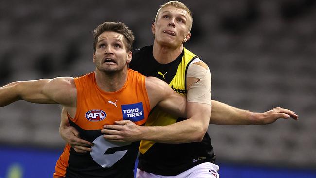 Former Tiger Ryan Garthwaite battles Giant Jesse Hogan. Picture: Michael Klein