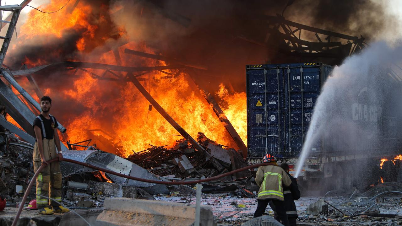 Firefighters douse a blaze at the scene of the explosion. Picture: AFP