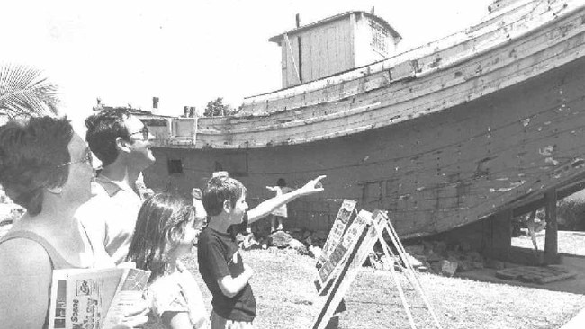 Middlemount family, Suzanne and Bill Ward, with children Melissa, 10, and Scott, 12, take a look at the old junk, which sat at the City Gates for many years. The family was enjoying a school holiday visit to Mackay in 1989. Photo: Daily Mercury Archives