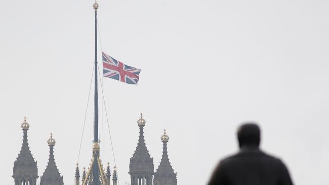 A Union flag flies at half mast from the Houses of Parliament after an attacker, ‘inspired by international terrorism’, killed three people. Picture: Daniel Leal-Olivas