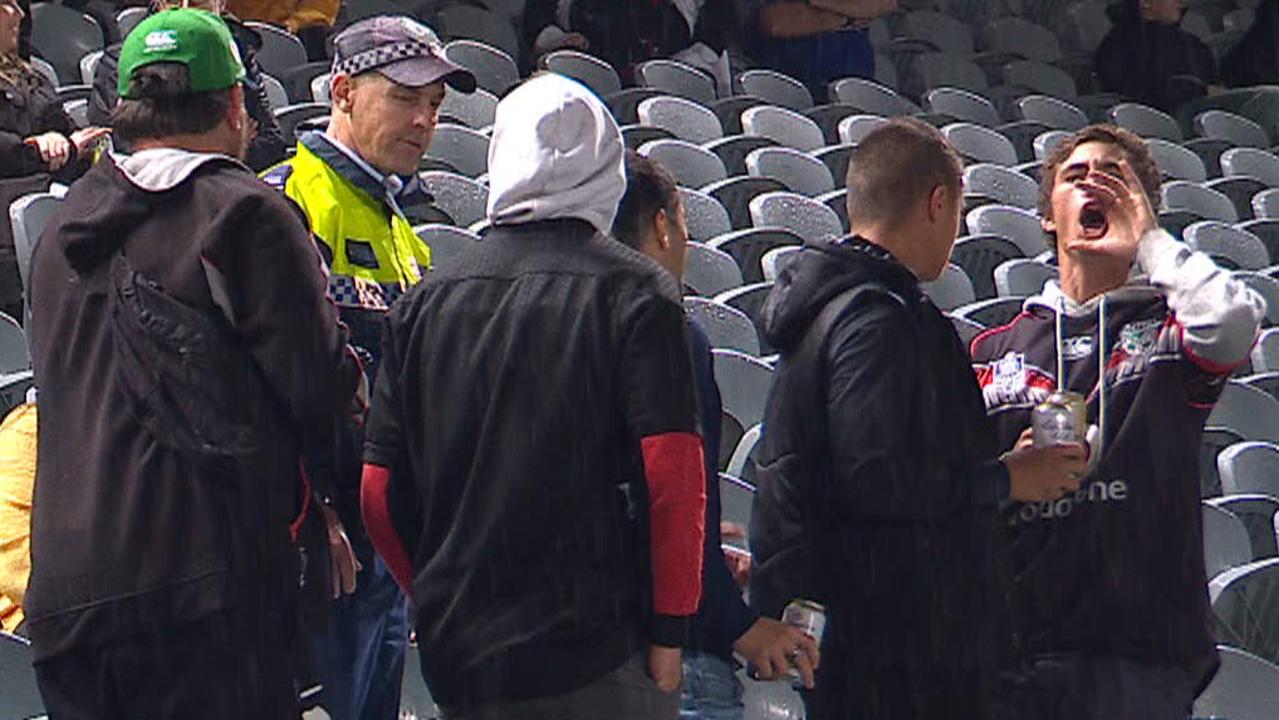 Police eject a group of spectators from the crowd for alleged racist abuse.