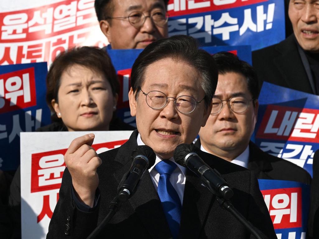 Main opposition Democratic Party leader Lee Jae-myung (C) speaks during a rally against President Yoon Suk Yeol.