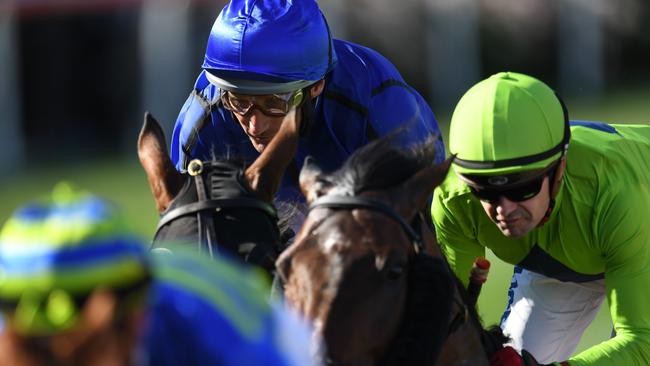 Damien Oliver (second from left) rides Happy Clapper alongside Royal Symphony ridden by Dean Yendall (right) during the Cox Plate at Moonee Valley racecourse in Melbourne, Saturday, October 28, 2017. (AAP Image/Julian Smith) NO ARCHIVING