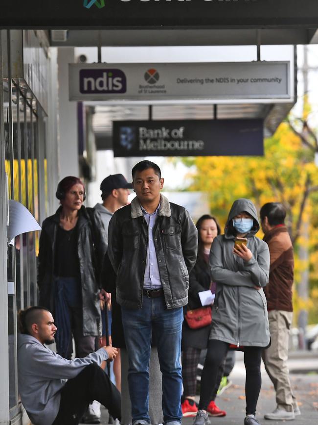 People queue up outside a Centrelink office in Melbourne on April 20.