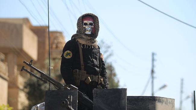 An Iraqi counter terrorism soldier wears a skull mask while on guard. Picture: AFP