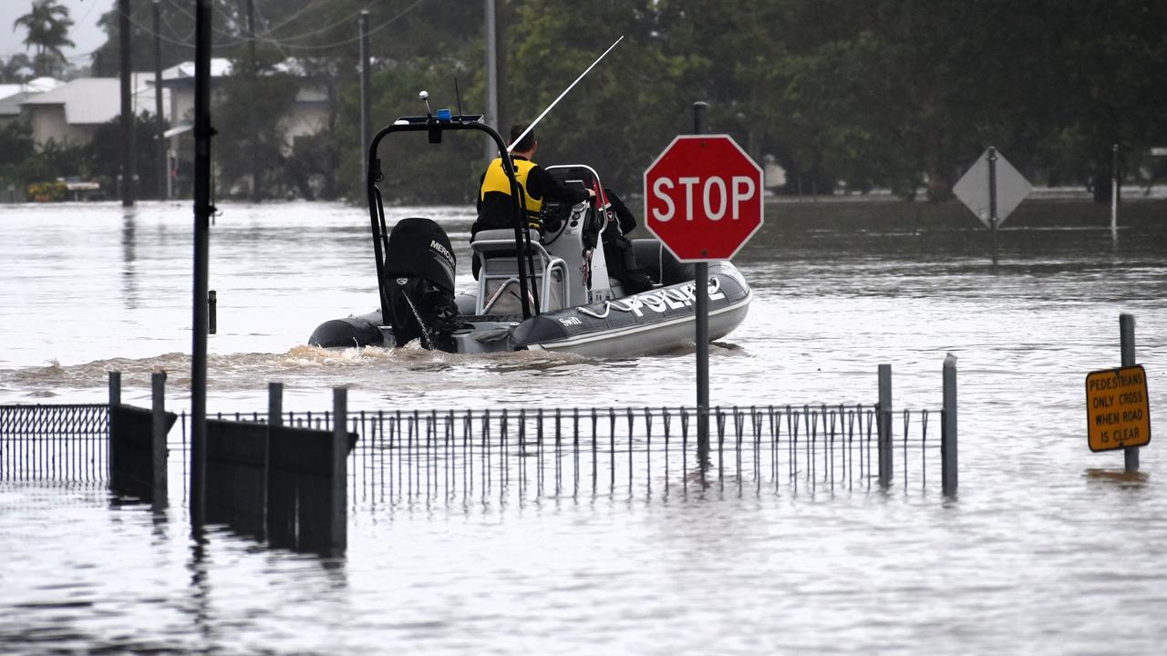 A Queensland Police Service rescue boat navigating floodwaters on the inundated intersection of Davidson and McIlwraith Street just off the Bruce Highway in Ingham. Picture: Cameron Bates