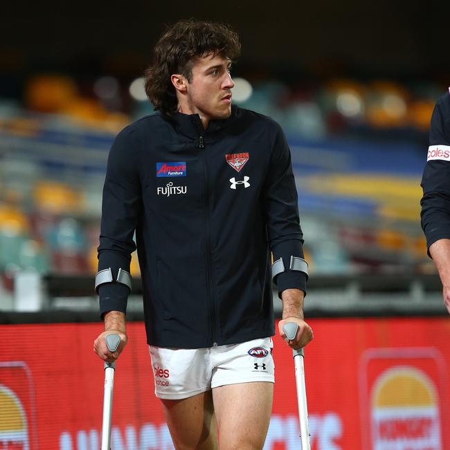 Andrew McGrath walks off on crutches after an injury last year. Picture: Getty Images