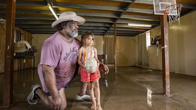 Shane Hooper and his daughter Felicity inspect the damage to their home caused by floodwaters. Picture: Lachie Millard