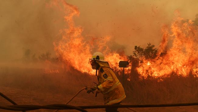 RFS Firefighters battle a spot fire on November 13, 2019 in Hillville, Australia, where the blaze has just been upgraded to emergency level. Picture: Getty Images)