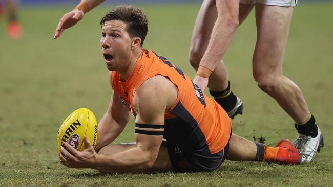 Toby Greene handballs from the ground. His five goals proved the difference for the Giants in the grand final rematch against Richmond. Picture. Phil Hillyard