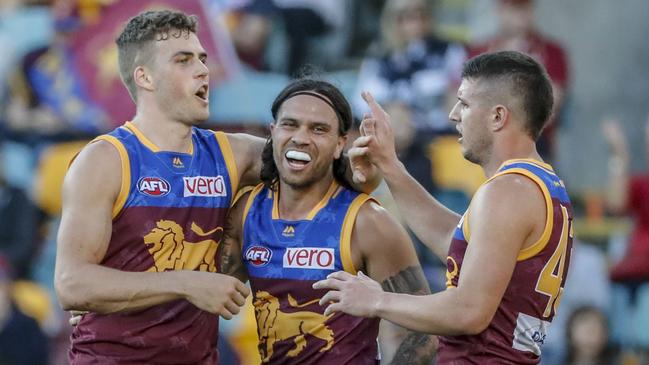 Tom Cutler of the Lions (left) celebrates a goal during the Round 16 AFL match between the Brisbane Lions and the Carlton Blues at the Gabba in Brisbane, Saturday, July 7, 2018. (AAP Image/Glenn Hunt) NO ARCHIVING, EDITORIAL USE ONLY