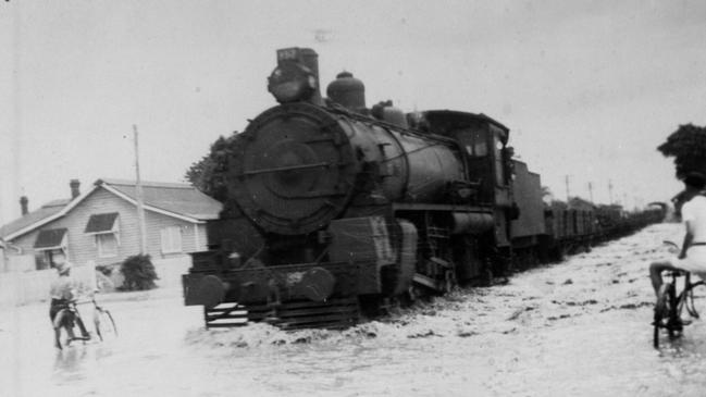 Perry Street, 1942 floods. A steam train passing through floodwaters that impacted the region during World War II. Source: Cal and Beth Toft Collection, Bundaberg Regional Council