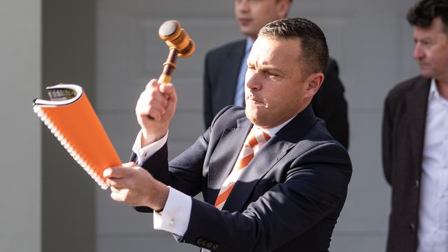 Auctioneer Damien Cooley bringing down the hammer at a Sydney auction last month. Picture: Julian Andrews