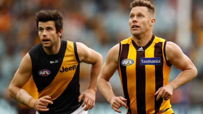 MELBOURNE, AUSTRALIA - JULY 24: Trent Cotchin of the Tigers and Sam Mitchell of the Hawks in action during the 2016 AFL Round 18 match between the Hawthorn Hawks and the Richmond Tigers at the Melbourne Cricket Ground on July 24, 2016 in Melbourne, Australia. (Photo by Michael Willson/AFL Media)