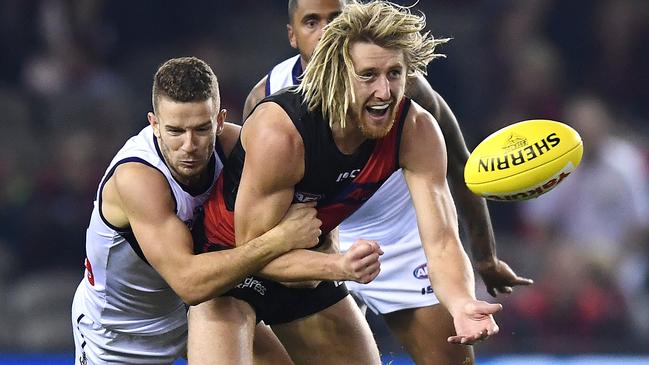 Fremantle’s Sam Switkowski tackles Essendon captain Dyson Heppell during their clash in May. Picture: Quinn Rooney/Getty Images.