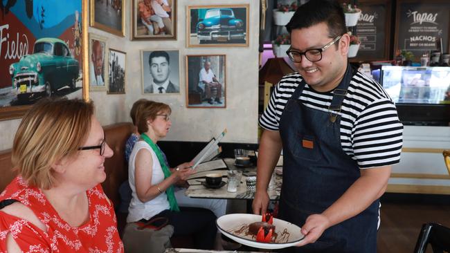 Coco Cubano waiter Roshan Simkhada serves a customer at the popular Parramatta restaurant. Picture: Angelo Velardo