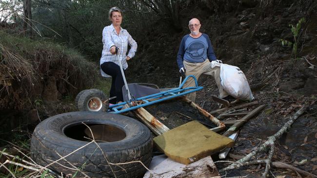 Deborah Clark and Col Burnett show some of the rubbish dumped at Noorumba Reserve at Rosemeadow. Picture: Robert Pozo