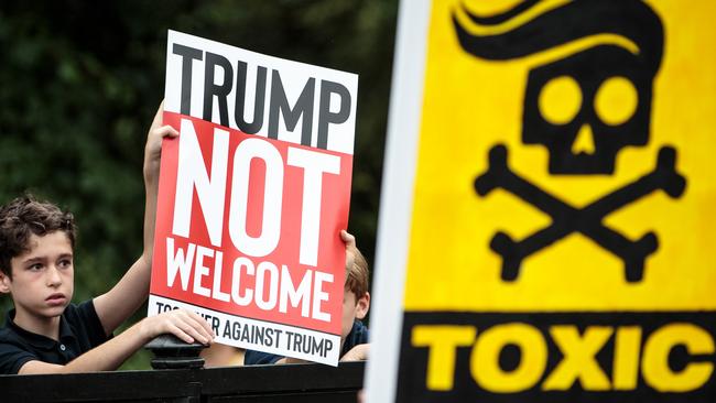 Protesters hold placards during a demonstration outside Winfield House. Photo: Getty Images