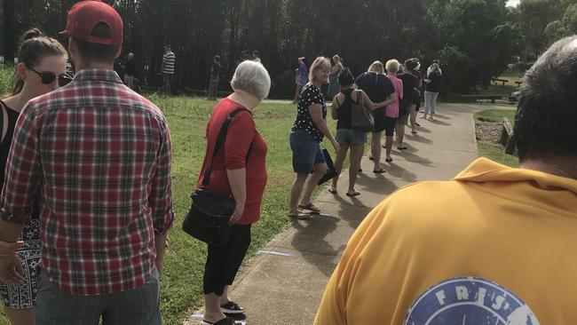 The line-up after the morning rush had thinned to about 30 or 40 people. Blue tape was placed on the path to encourage social distancing.