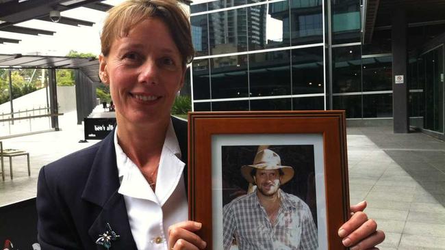 Wamuran's Andrea Mafliet, guidance officer at Woodford, with a photo of her partner Gavin Woods, who was deputy principal at Burpengary State School before taking his own life. Picture: Rae Wilson