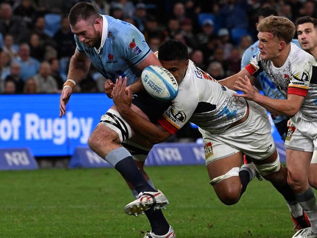 Tupou Vaai’s tackle forces the ball out of Waratahs’ Jed Holloway’s hands. Picture: AFP