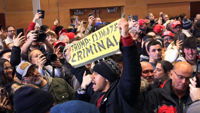 A demonstrator is removed as Republican presidential candidate former President Donald Trump speaks to supporters during a rally at Simpson College on January 14, 2024 in Indianola, Iowa. Picture: Scott Olson/Getty Images/AFP