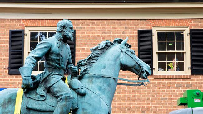 People watch as the statue of Confederate General Thomas Stonewall Jackson is removed from a park to be taken to storage in Charlottesville, Virginia, in July 10. Picture: AFP