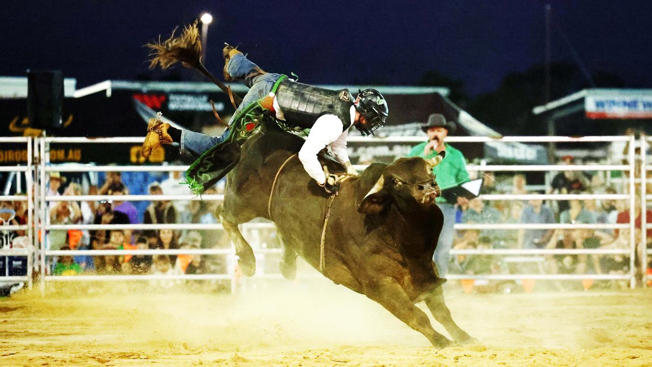 Corey Mitchell is bucked from his ride in the novice bull ride at the 2024 Cairns Bull Throttle event, a bikes and bulls show, featuring bull riding and freestyle motocross riders at the Cairns Showgrounds. Picture: Brendan Radke