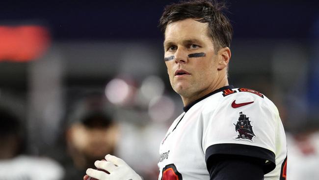 (FILES) In this file photo taken on October 2, 2021 Tom Brady #12 of the Tampa Bay Buccaneers warms up on the sideline during the game against the New England Patriots at Gillette Stadium in Foxborough, Massachusetts. - Tom Brady's return October 3, 2021 to face his former NFL team, the New England Patriots, racked up enormous American viewing numbers making it one of the most watched "Sunday Night Football" games in history. (Photo by Maddie Meyer / GETTY IMAGES NORTH AMERICA / AFP)