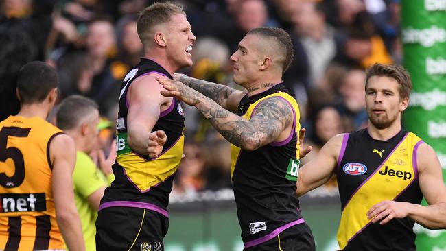 Josh Caddy and Dustin Martin celebrate a goal against Hawthorn.