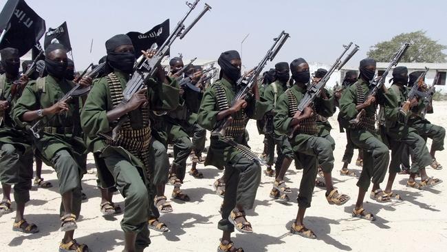 FILE- In this Feb.17, 2011 file photo, hundreds of newly trained al-Shabab fighters perform military exercises in the Lafofe area some 18 kilometers (12 miles) south of Mogadishu, Somalia. U.S. military forces targeted the Islamic extremist al-Shabab network in an operation Monday, Sept. 1, 2014 in Somalia, the Pentagon said. (AP Photo/Farah Abdi Warsameh, File)