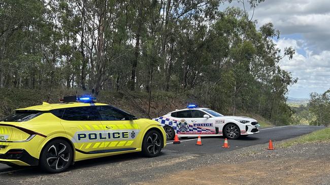 Police at the scene of the fatal crash where a Bardon cyclist collided with a car.