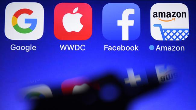 Google, Apple, Facebook and Amazon applications are seen on a large screen. Picture: AFP