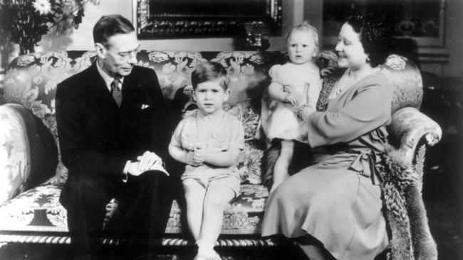 Queen Mother holds Princess Anne, while husband King George VI watches Prince Charles (later Charles III) in 1951. Picture: Central Press