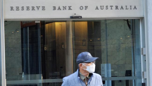 A man walks past the Reserve Bank of Australia building in the central business district of Sydney today. Picture: AFP