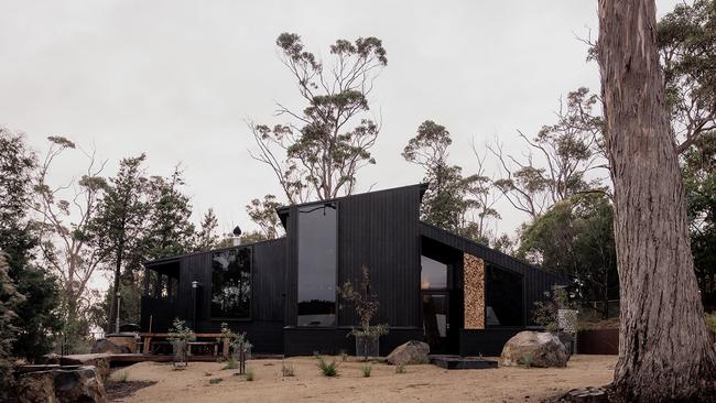 Sisters’s stylish dark timber-clad exterior helps the shack blend into its bush setting. Picture: Supplied