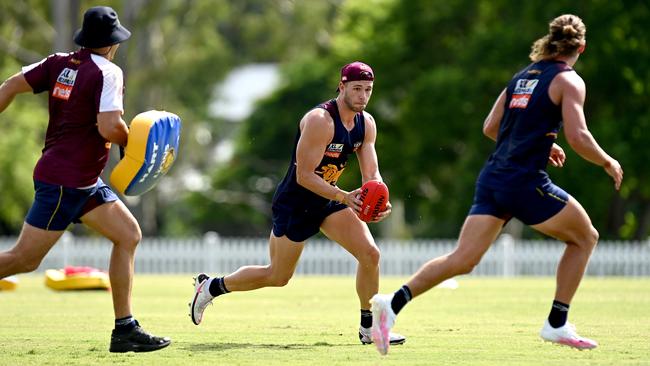 Ely Smith takes on the defence during a Brisbane Lions training session.