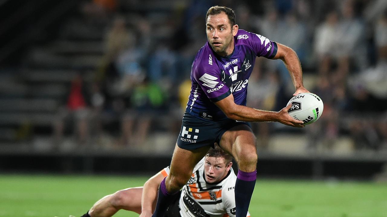 Cameron Smith evades the tackle of Harry Grant