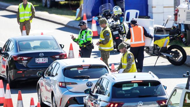 Police and the Army at the Queensland-NSW border on the Gold Coast Highway. Picture: Nigel Hallett