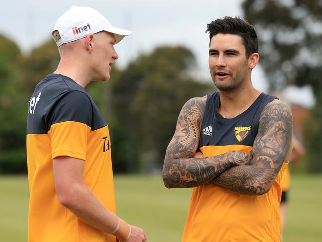 Chad Wingard, right, chats to James Sicily in his first appearances as a Hawk.