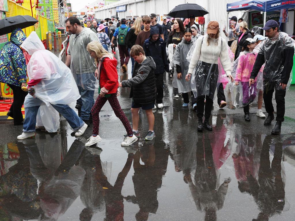 Punters dodging puddles on People’s Day. Picture: Liam Kidston