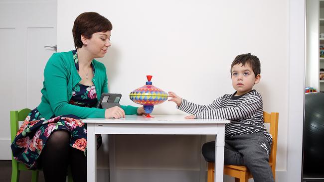 Julie Coorey with son Michael at their Lance Cove home. She says further research was needed on the suramin study.