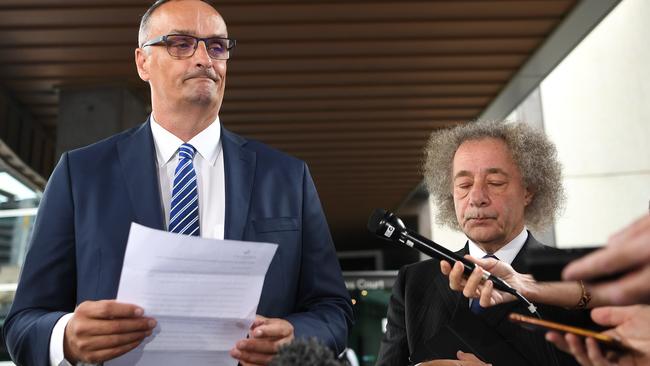 Ardent Leisure CEO John Osborne (left) and chairman Gary Weiss address the media outside the Magistrates Court in Brisbane. Picture: AAP