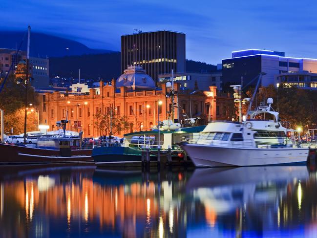 Australia Tasmania Hobart sullivan's cove at sunset illuminated buildings gallery and docked yachts with lightsFor Escape in Gold Coast Eye