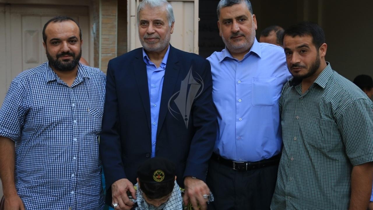 Fayez Elhasani (second left) standing with a young boy, believed to be his grandson, in military clothing and a senior leader of the Palestinian Islamic Jihad's politburo, Ahmad Al-Mudallal (right) at a 2017 memorial for his son Remah.