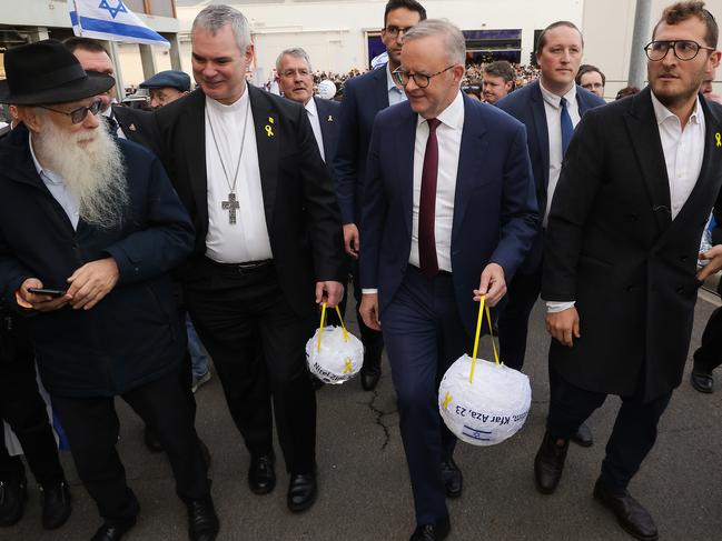 Prime Minister Anthony Albanese carries a lantern at the vigil in Melbourne on the first anniversary of the Hamas attacks in Israel. Picture: Ian Currie