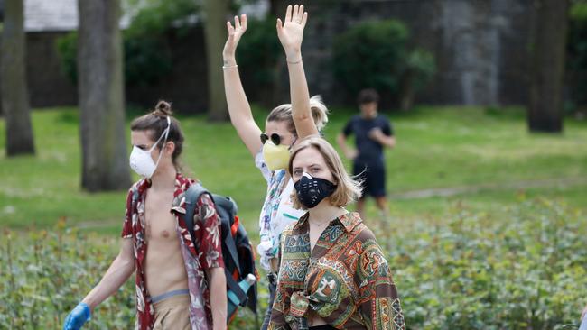 People wear face masks as they take their daily exercise in Victoria Park in east London. Picture: AFP