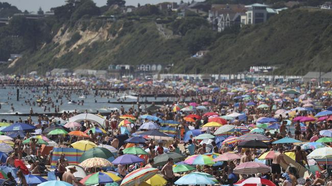 Crowds gather on the beach in Bournemouth as the UK experience a heatwave, in Bournemouth, England, Thursday, June 25, 2020. (Andrew Matthews/PA via AP)